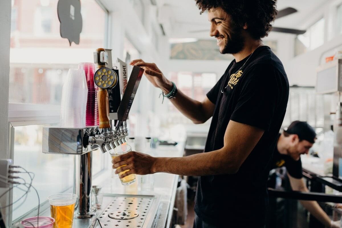 A man pours beer from a tap in Redding, California