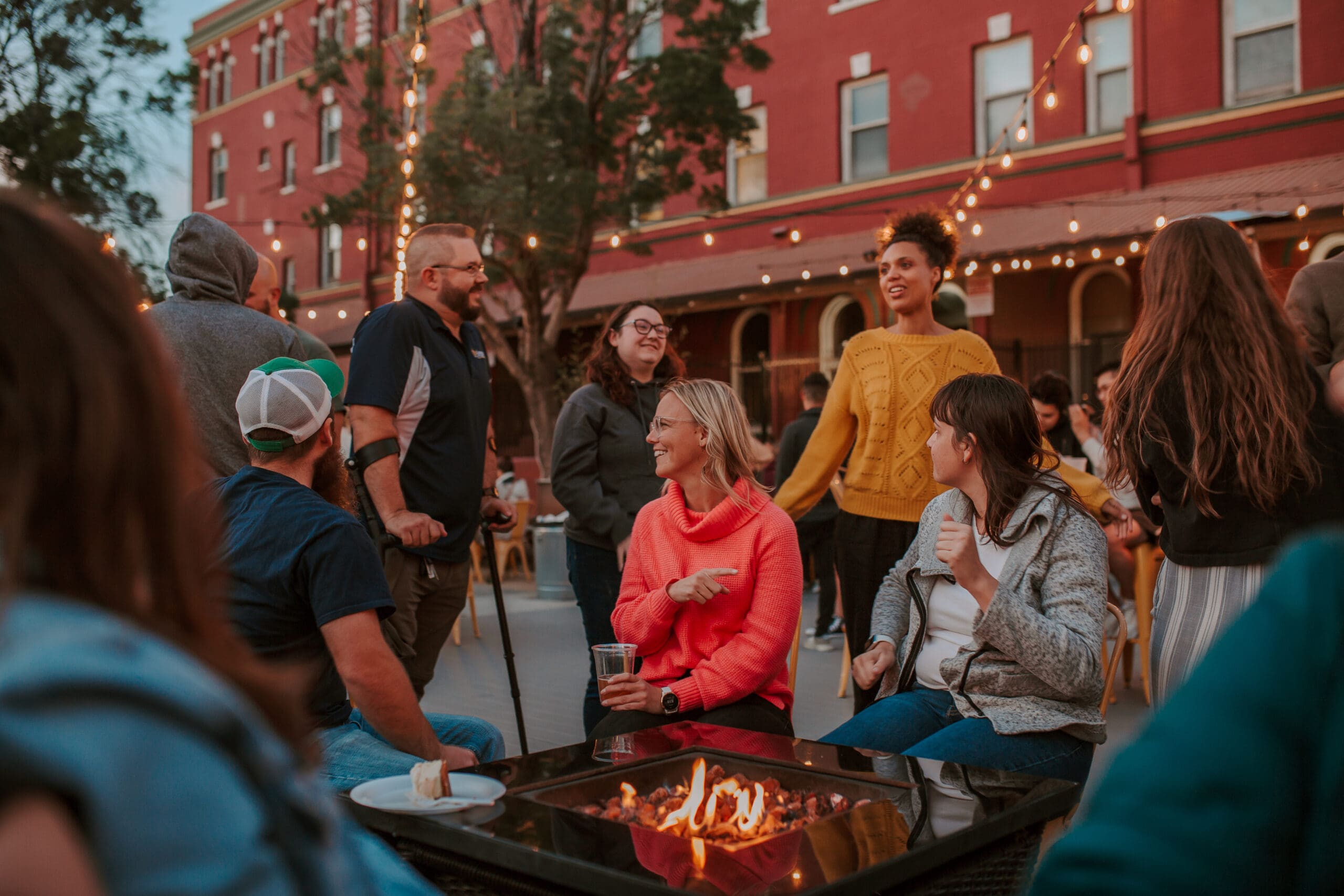 A group of friends around a fire pit at The Park in downtown Redding