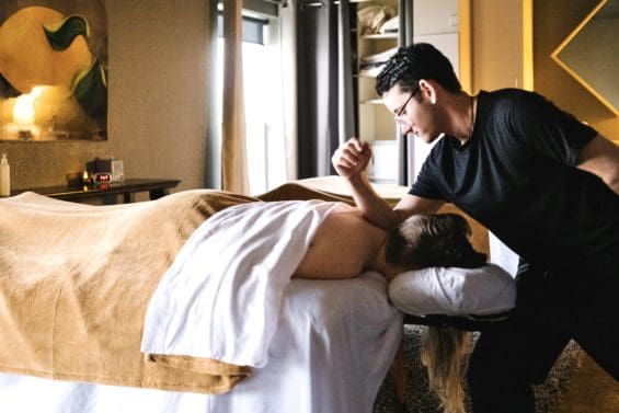 A massage therapist giving a woman a massage with his elbow at urban retreat in redding ca