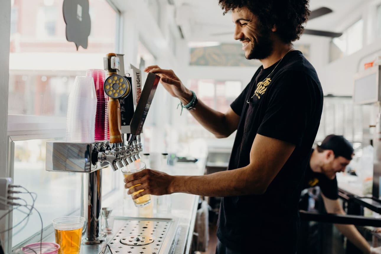 A man pours beers from a tap in Redding, CA