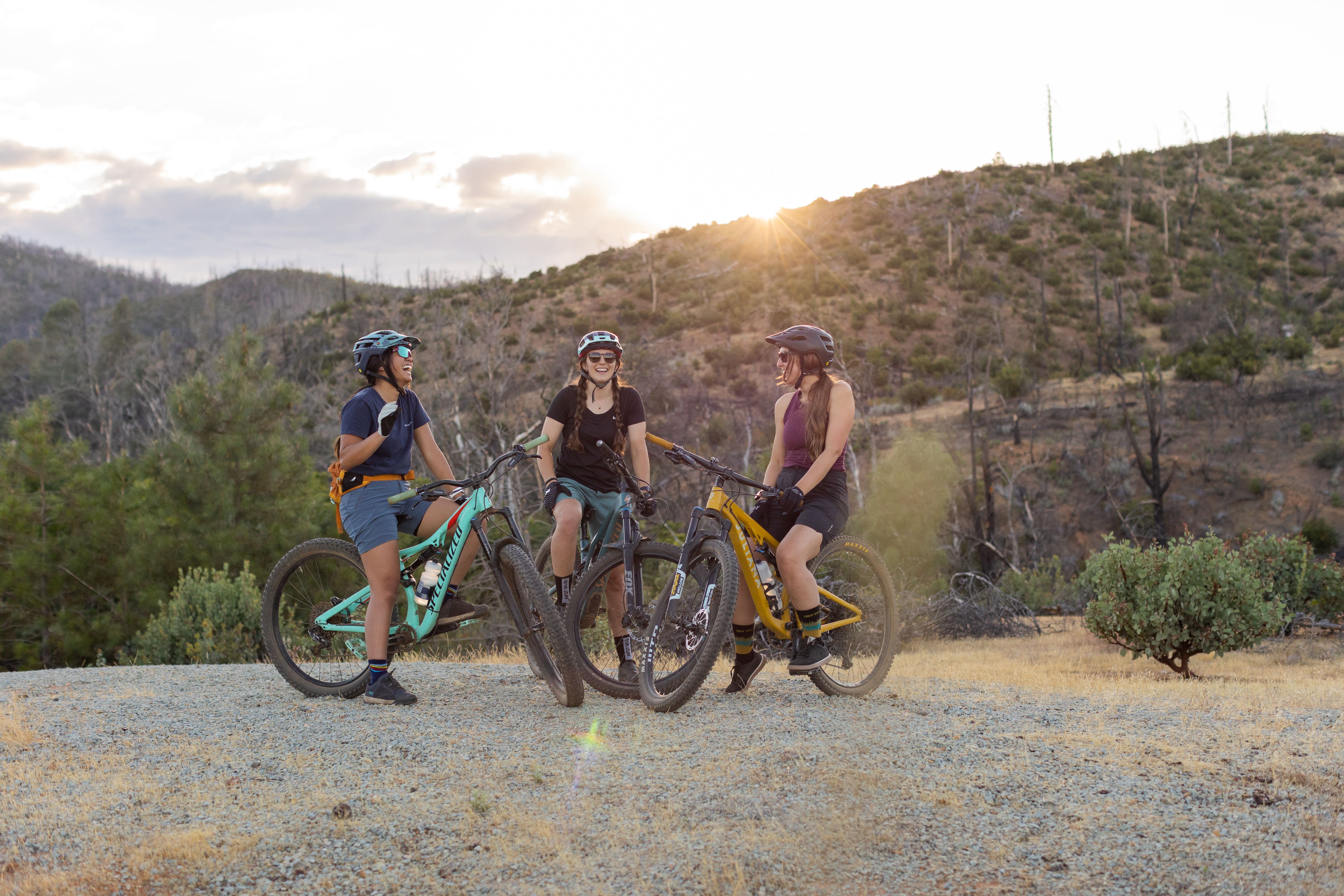 Three ladies on bikes riding a trail in Redding, CA